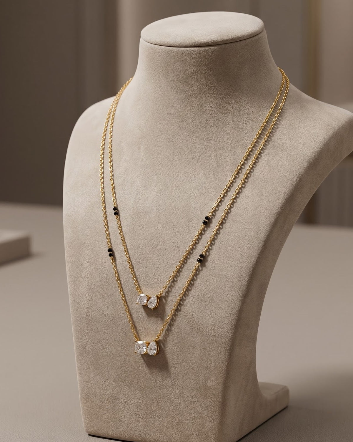 Solvyn Stone Duo Mangalsutra displayed on a jewelry stand showing chain length and beads