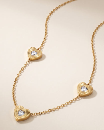 Solita Trio Heart Chain Necklace — gold-tone chain with three fluted CZ heart stations, laid flat