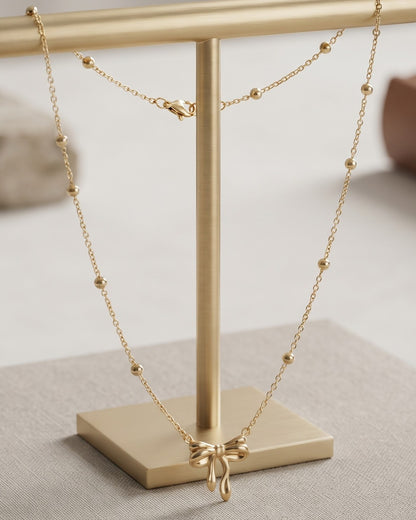 Solenne Bow Pendant Necklace – On display stand
