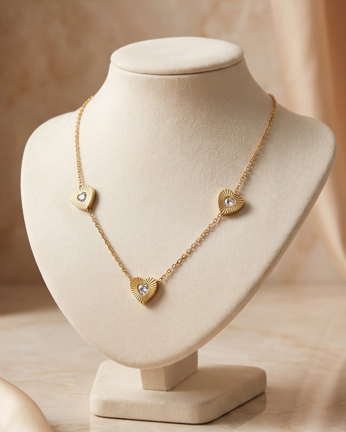 Solita Trio Heart Chain Necklace displayed on a jewelry stand showing chain length and heart stations