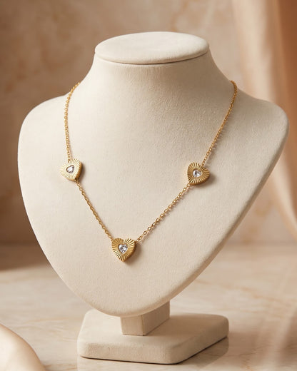 Solita Trio Heart Chain Necklace displayed on a jewelry stand showing chain length and heart stations