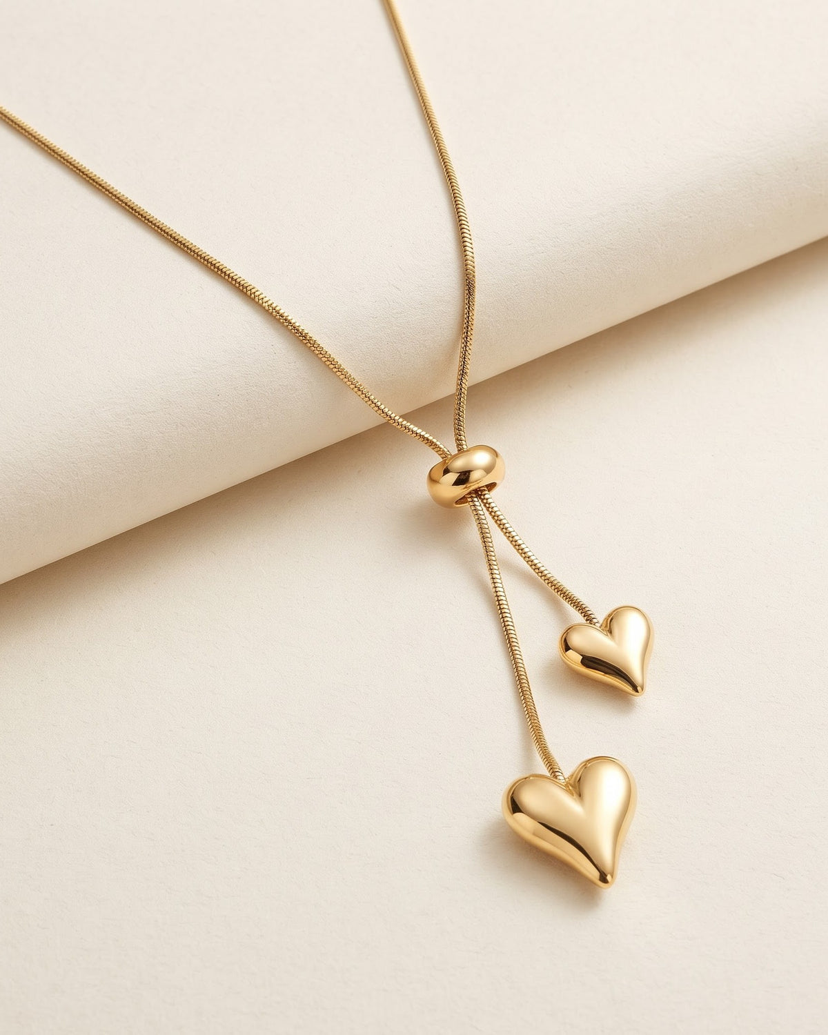 Solnelle Twin Heart Lariat Necklace - gold-tone adjustable lariat necklace with two puffed hearts