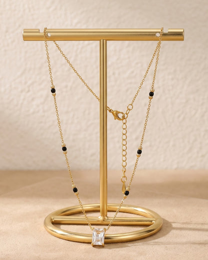 Solreya Baguette Solitaire Mangalsutra displayed on a jewelry stand showing chain length