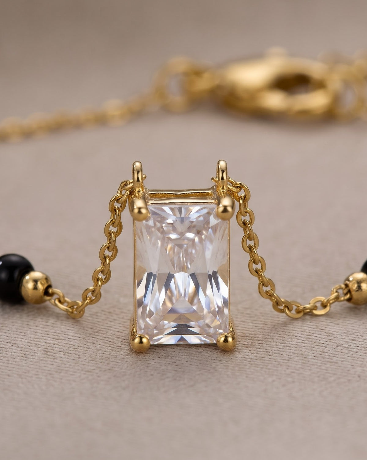 Cinematic close-up of the Solreya Baguette Solitaire Mangalsutra chain and a bezel-set baguette cubic zirconia solitaire