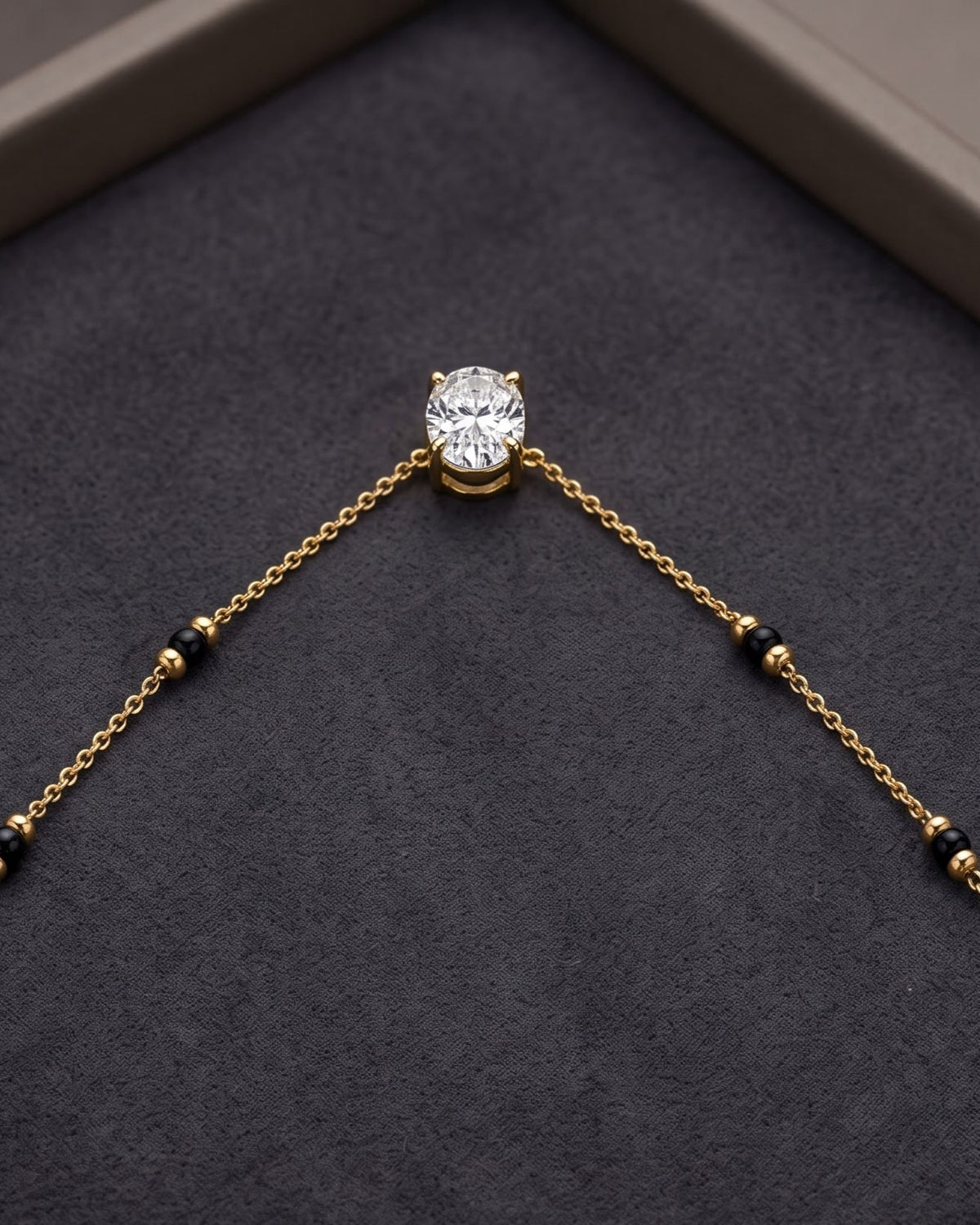 Close-up detail of the Solyne Oval Solitaire Mangalsutra a bezel-set oval cubic zirconia solitaire