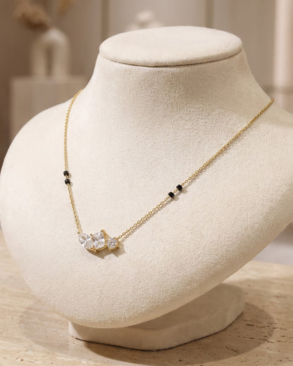 Solyra Stone Trio Mangalsutra displayed on a jewelry stand showing chain length