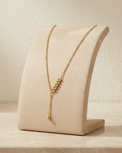 Solenta Wheat Spike Lariat Necklace — on display stand