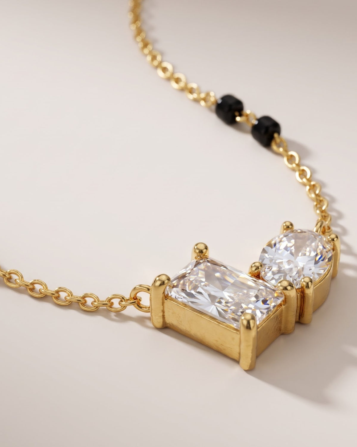 Cinematic close-up of the Solvana Baguette Duo Mangalsutra chain and a baguette and oval cubic zirconia duo