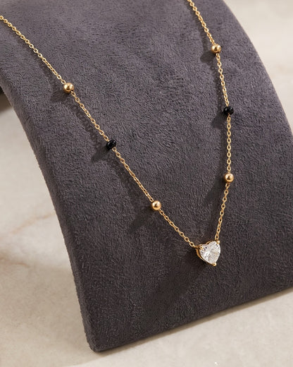 Solura Heart Mangalsutra displayed on a jewelry stand showing chain length