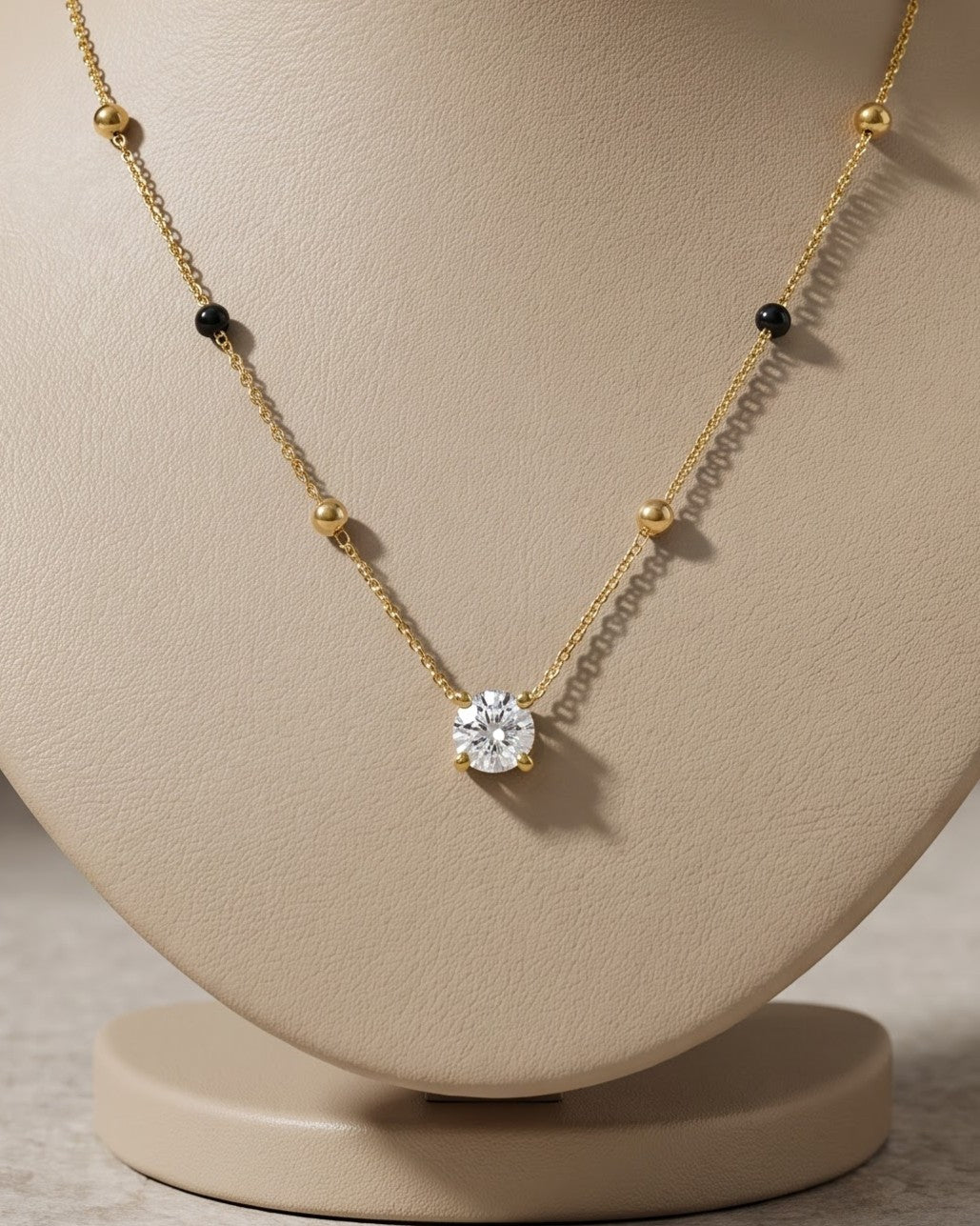 Solyma Round Solitaire Mangalsutra displayed on a jewelry stand showing chain length