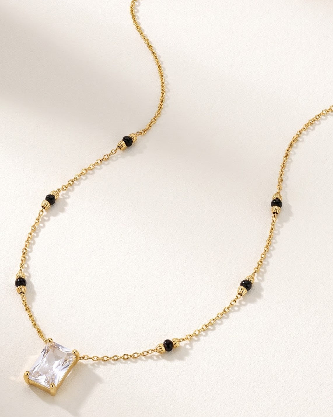 Close-up detail of the Solreya Baguette Solitaire Mangalsutra a bezel-set baguette cubic zirconia solitaire