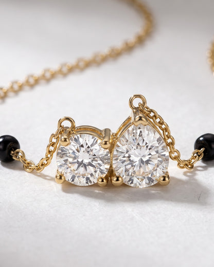 Cinematic close-up of the Solveya Drop Duo Mangalsutra chain and a pear-cut and round-cut cubic zirconia duo