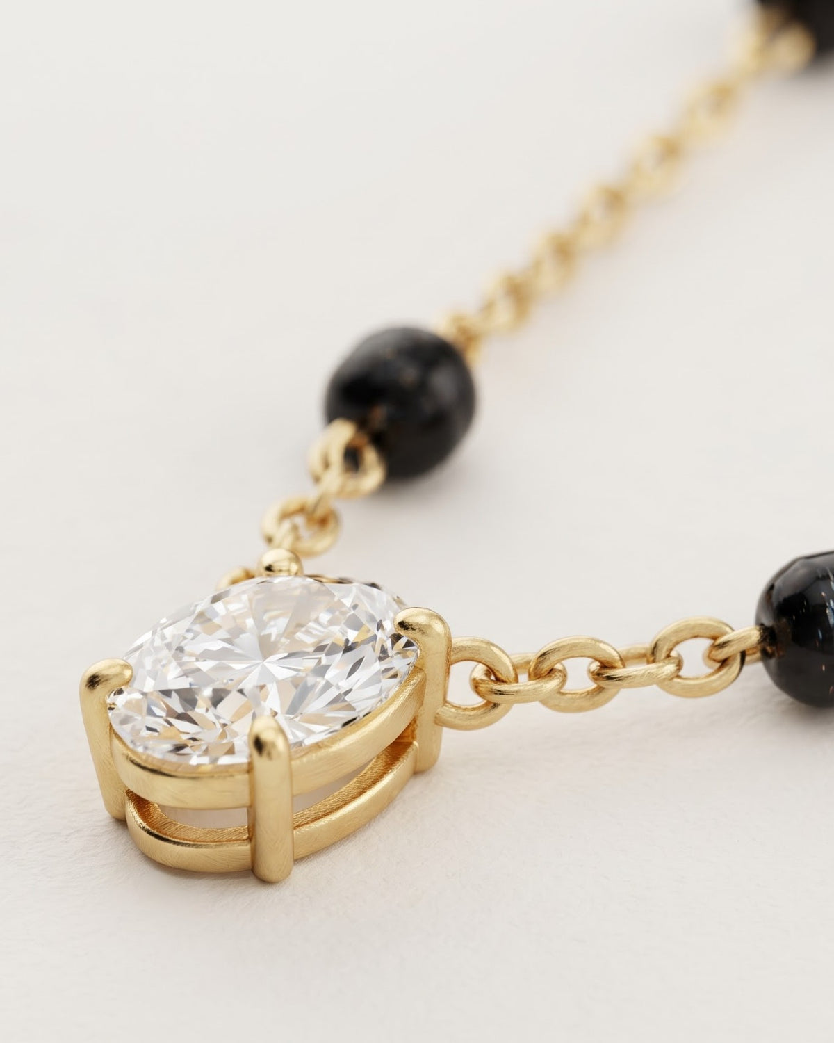 Cinematic close-up of the Solveth Drop Solitaire Mangalsutra chain and a pear-cut cubic zirconia solitaire