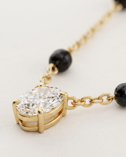 Cinematic close-up of the Solveth Drop Solitaire Mangalsutra chain and a pear-cut cubic zirconia solitaire
