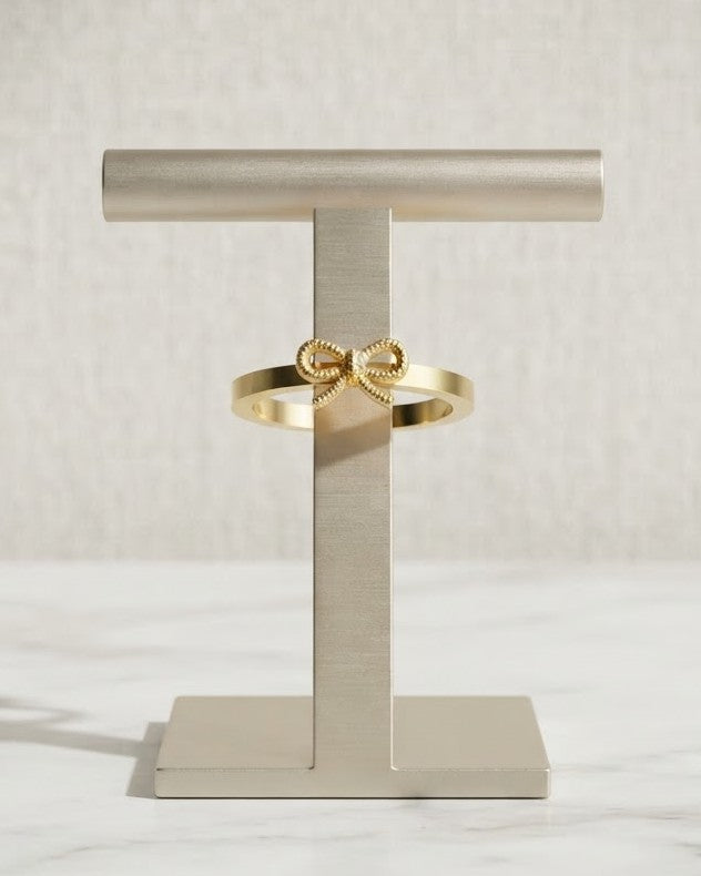 Solbrie Bow Statement Ring — on display stand