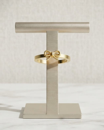 Solbrie Bow Statement Ring — on display stand