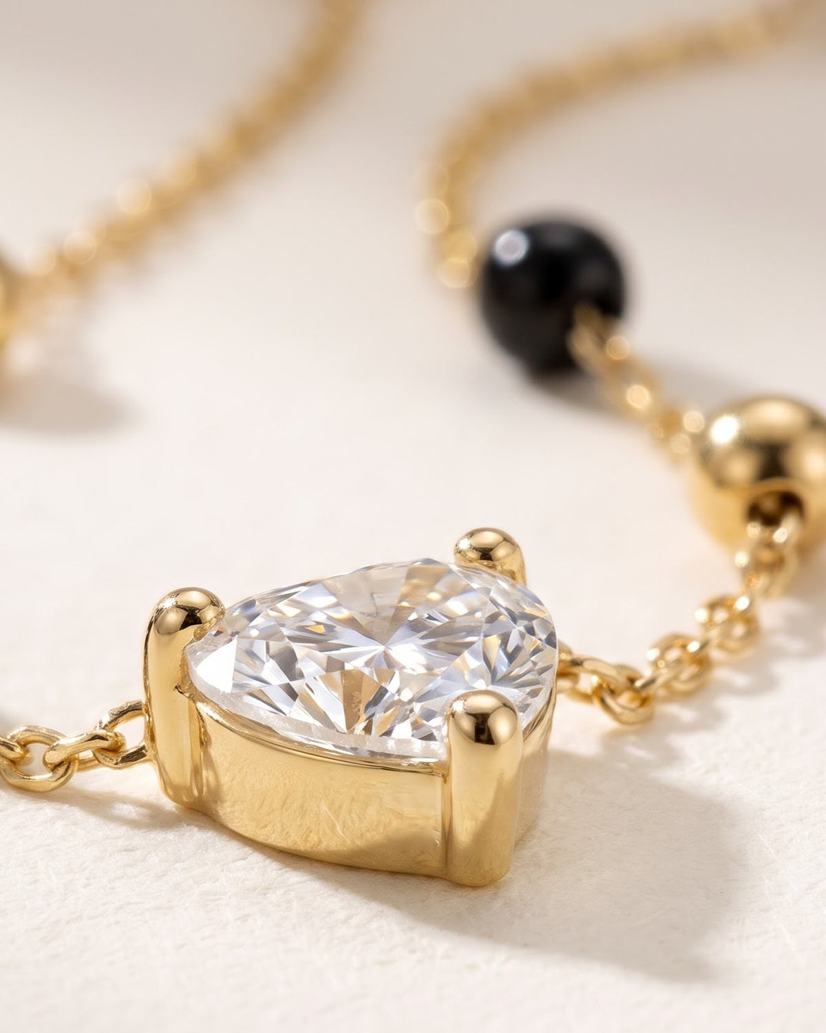 Cinematic close-up of the Solura Heart Mangalsutra chain and a heart-shaped cubic zirconia pendant