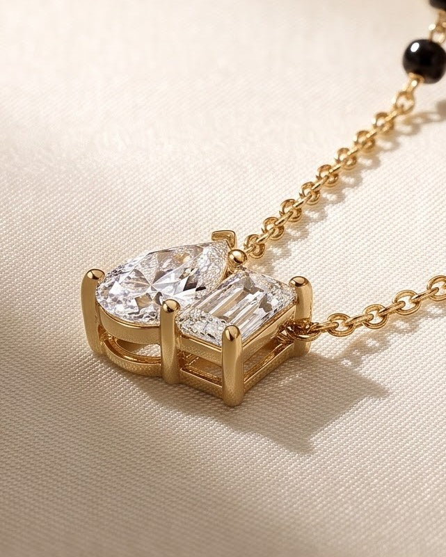 Cinematic close-up of the Solyna Teardrop Duo Mangalsutra chain and a pear-cut and baguette-cut cubic zirconia duo