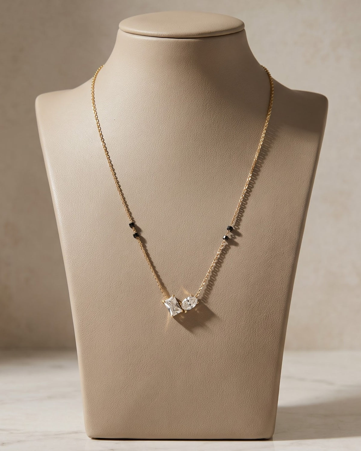 Solvana Baguette Duo Mangalsutra displayed on a jewelry stand showing chain length