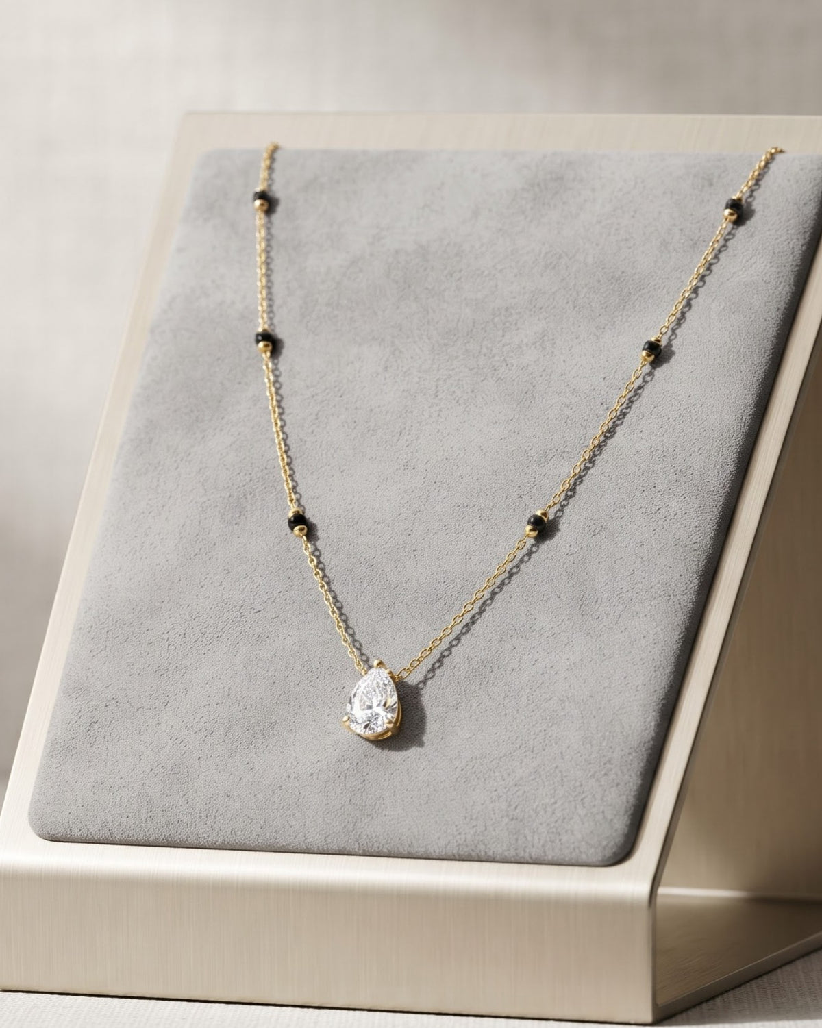 Solveth Drop Solitaire Mangalsutra displayed on a jewelry stand showing chain length