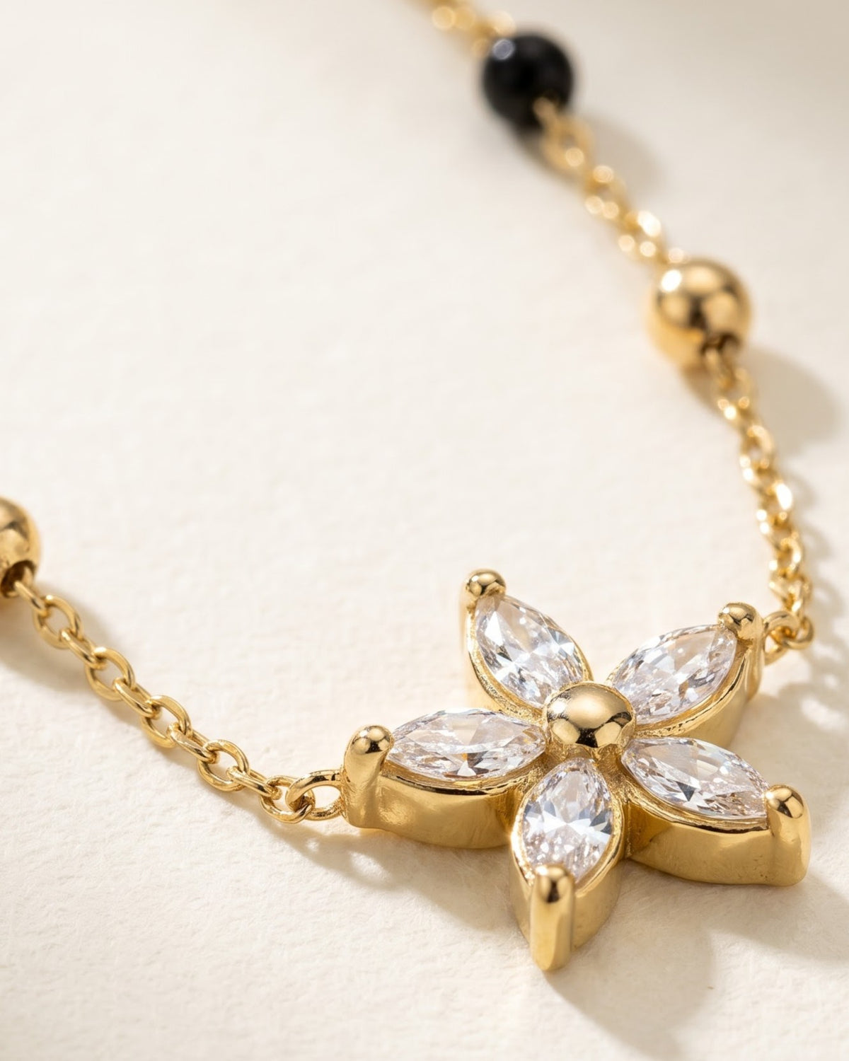 Cinematic close-up of the Solyssa Blossom Mangalsutra chain and a six-petal marquise cubic zirconia flower